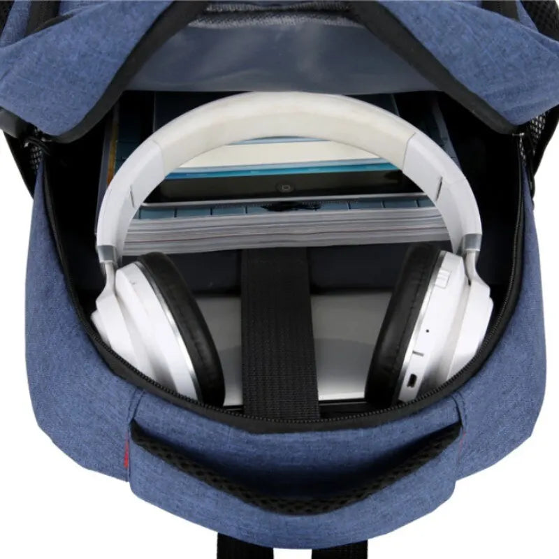 Blue backpack with a white gaming headset inside on a white background