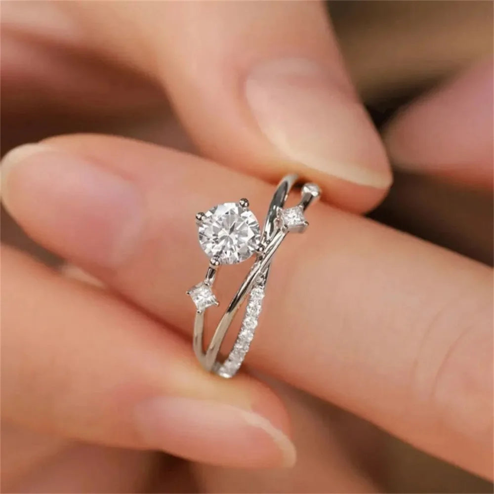 Silver ring with a diamond on a finger against a blurred background - The Tottos