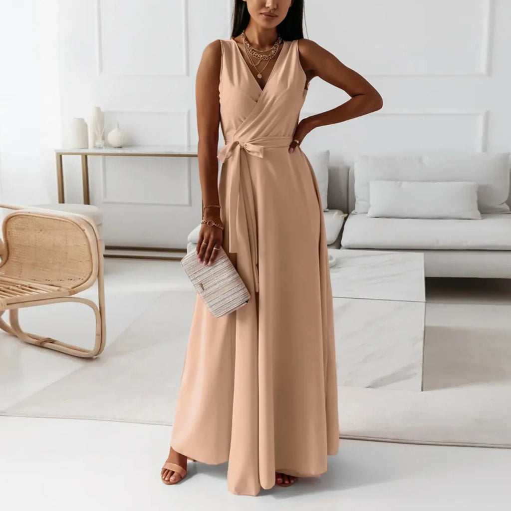Woman in a beige dress standing in a modern living room.