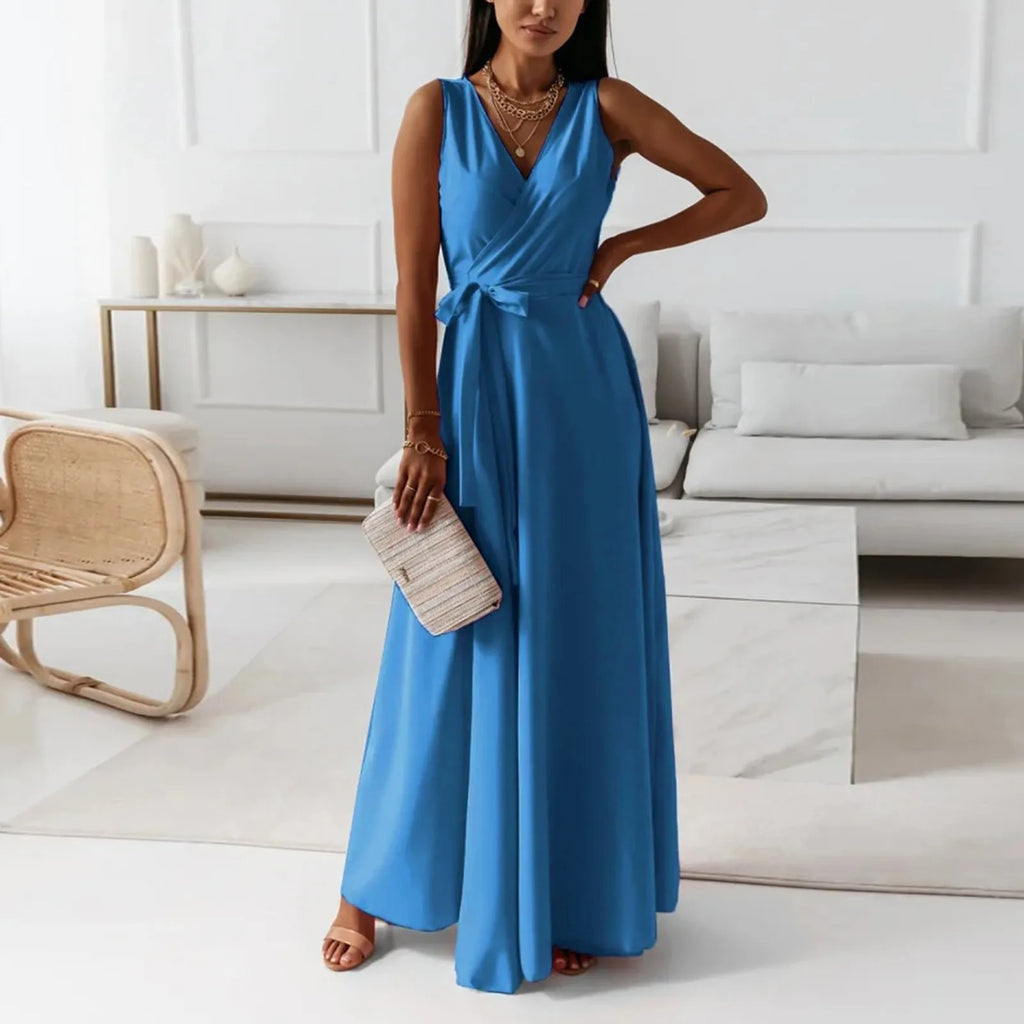 Woman in a blue dress standing in a modern living room.