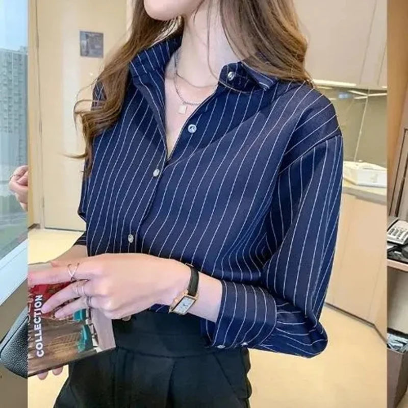 Woman wearing a blue striped shirt  in an office setting - The Tottos