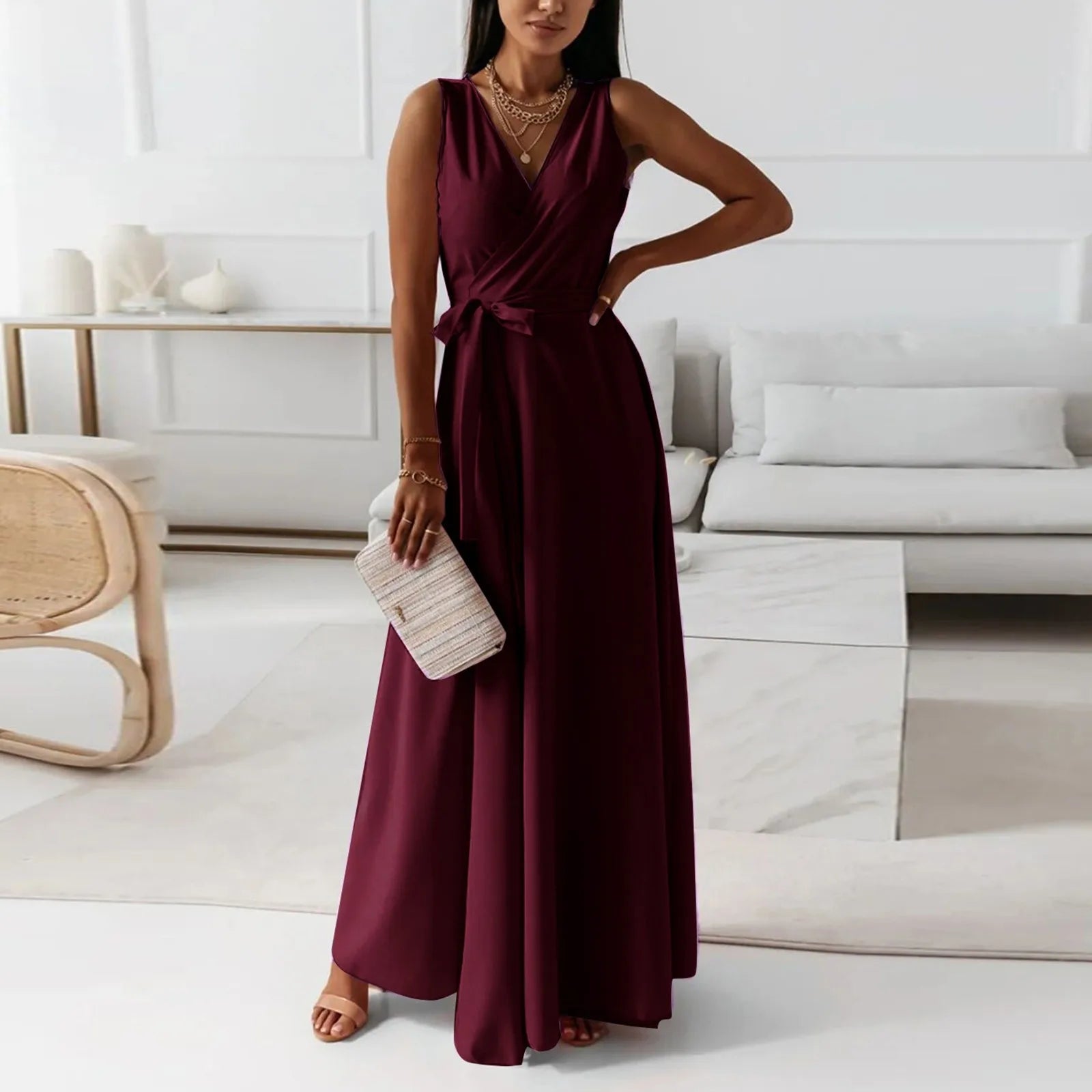 Elegant woman in a burgundy dress standing in a modern living room – The Tottos
