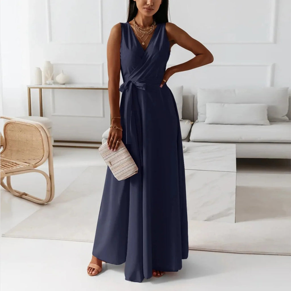 Elegant woman wearing a navy blue dress in a modern living room – The Tottos