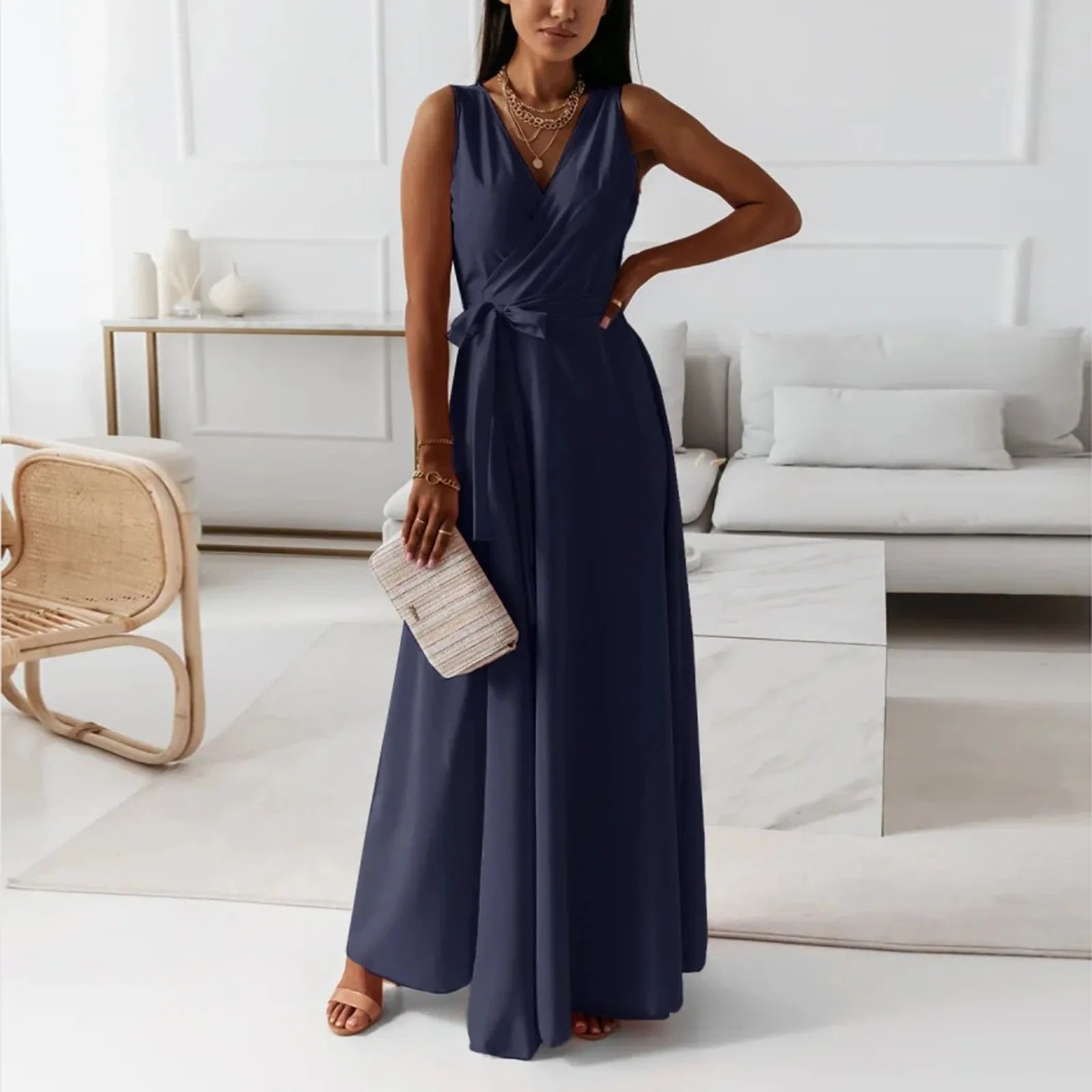 Elegant woman wearing a navy blue dress in a modern living room – The Tottos