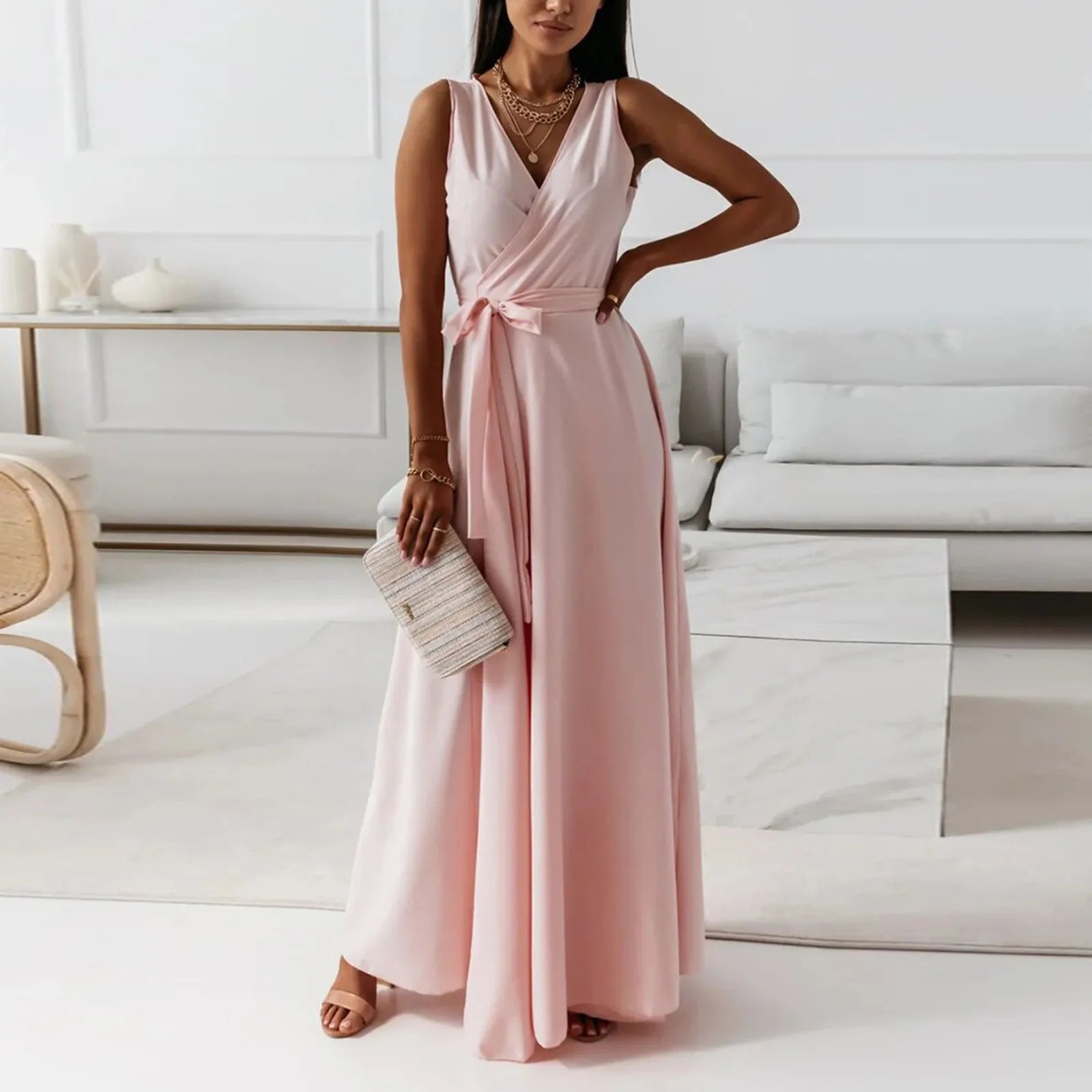 Elegant woman in a pink dress standing in a modern living room – The Tottos