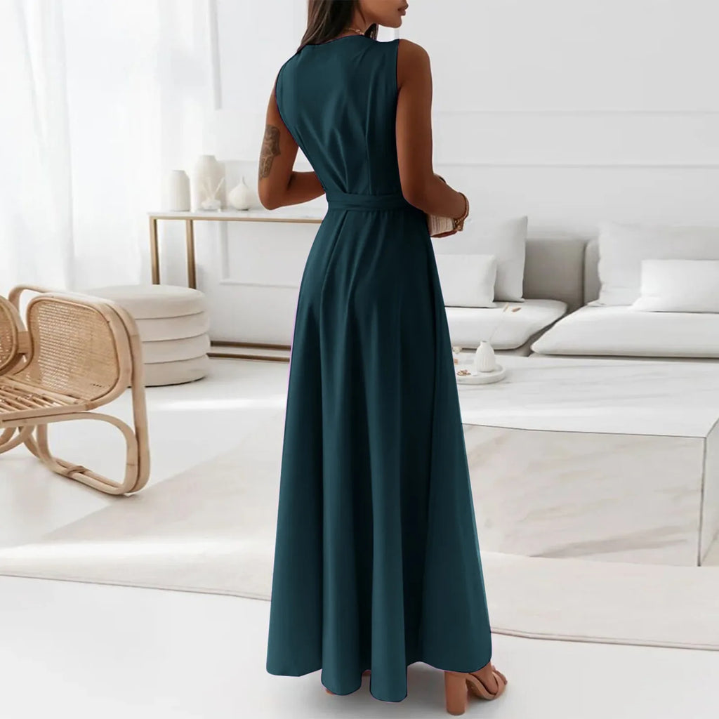 Elegant woman wearing a teal dress in a modern living room setting – The Tottos